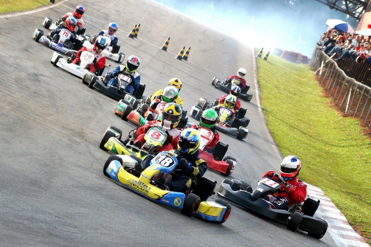A pack of karts racing away from the start